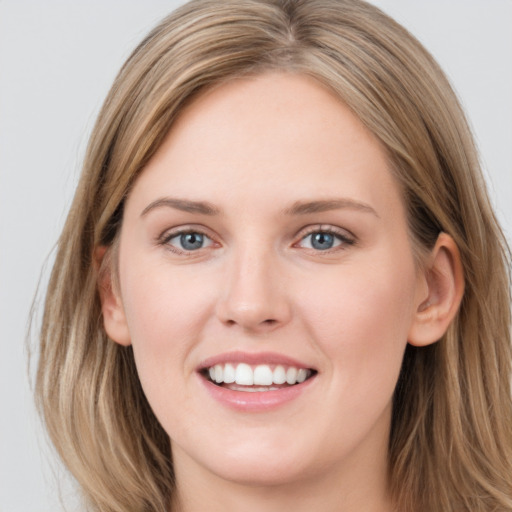 Joyful white young-adult female with long  brown hair and grey eyes