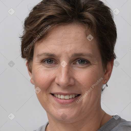 Joyful white adult female with short  brown hair and grey eyes