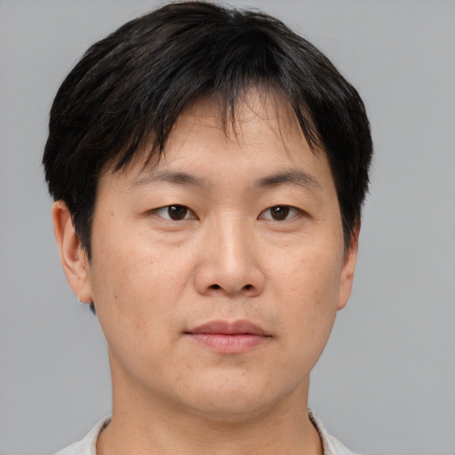 Neutral asian adult male with short  brown hair and brown eyes