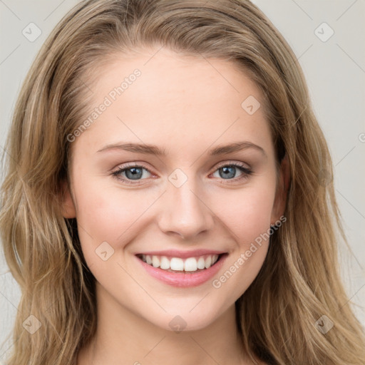 Joyful white young-adult female with long  brown hair and blue eyes