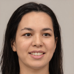 Joyful asian young-adult female with long  brown hair and brown eyes