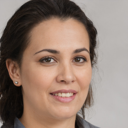 Joyful white young-adult female with medium  brown hair and brown eyes