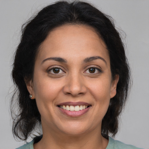 Joyful white adult female with medium  brown hair and brown eyes