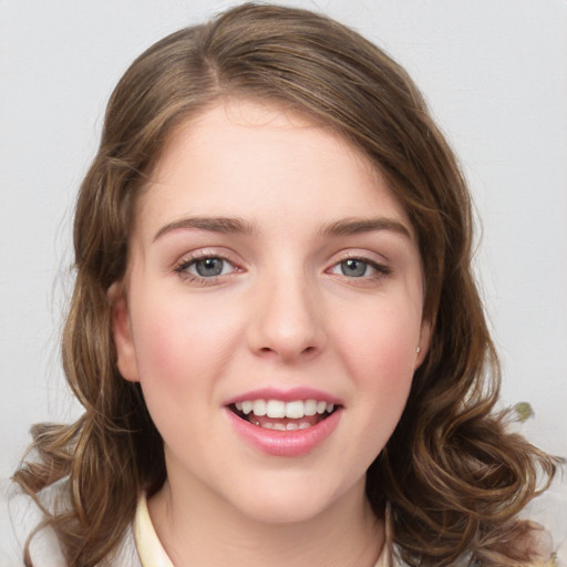 Joyful white young-adult female with medium  brown hair and green eyes