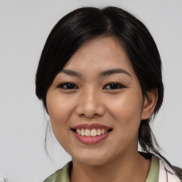 Joyful asian young-adult female with medium  black hair and brown eyes