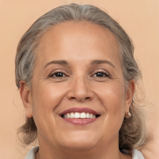 Joyful white adult female with medium  brown hair and brown eyes