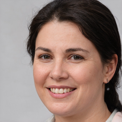 Joyful white adult female with medium  brown hair and brown eyes