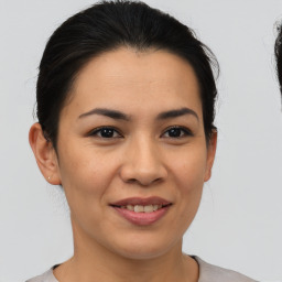 Joyful asian young-adult female with medium  brown hair and brown eyes