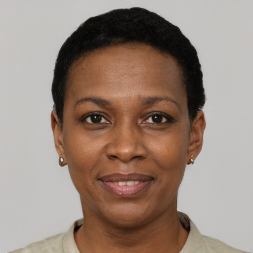 Joyful black young-adult female with short  black hair and brown eyes