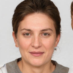 Joyful white adult female with medium  brown hair and grey eyes