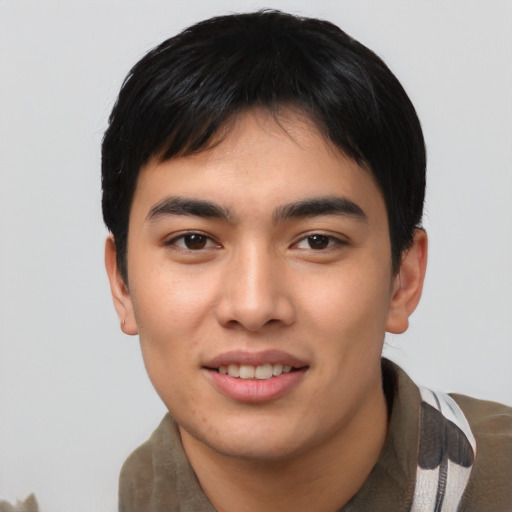Joyful asian young-adult male with short  black hair and brown eyes