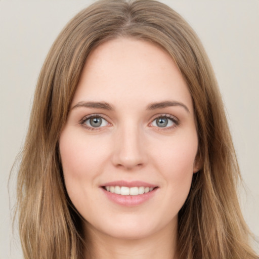 Joyful white young-adult female with long  brown hair and green eyes