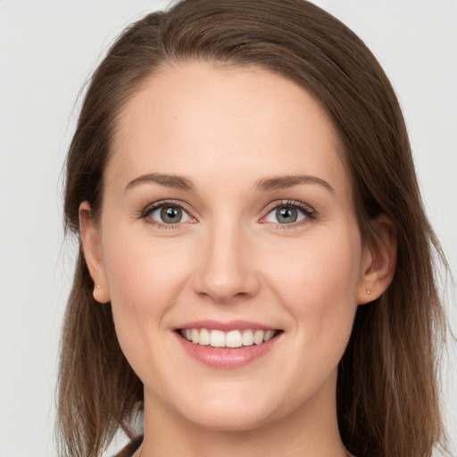 Joyful white young-adult female with long  brown hair and grey eyes