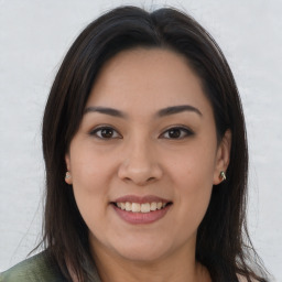 Joyful asian young-adult female with long  brown hair and brown eyes