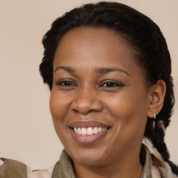 Joyful latino adult female with medium  brown hair and brown eyes