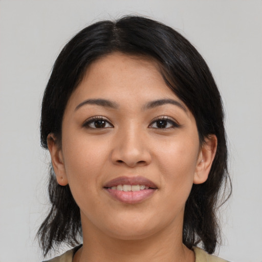 Joyful latino young-adult female with medium  black hair and brown eyes
