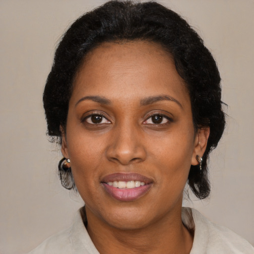 Joyful black adult female with medium  black hair and brown eyes