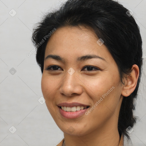 Joyful asian young-adult female with medium  brown hair and brown eyes