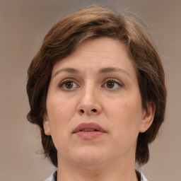 Joyful white adult female with medium  brown hair and brown eyes