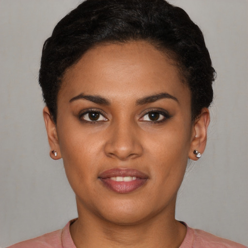 Joyful latino young-adult female with short  black hair and brown eyes