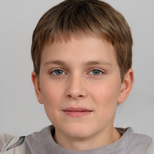 Joyful white child male with short  brown hair and grey eyes