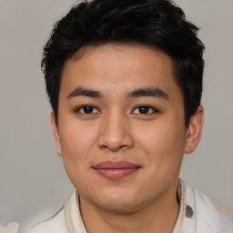 Joyful asian young-adult male with short  brown hair and brown eyes