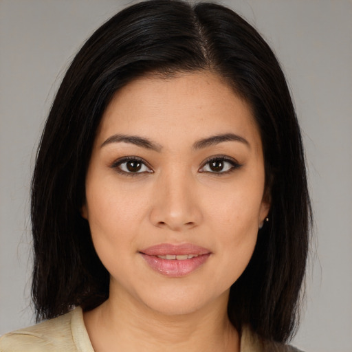 Joyful latino young-adult female with medium  brown hair and brown eyes