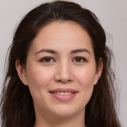 Joyful white young-adult female with long  brown hair and brown eyes