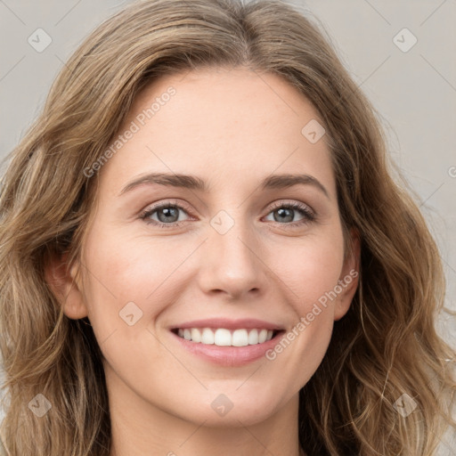 Joyful white young-adult female with long  brown hair and green eyes