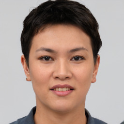 Joyful asian young-adult female with short  brown hair and brown eyes