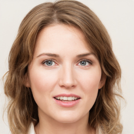 Joyful white young-adult female with medium  brown hair and green eyes