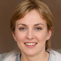 Joyful white young-adult female with medium  brown hair and blue eyes