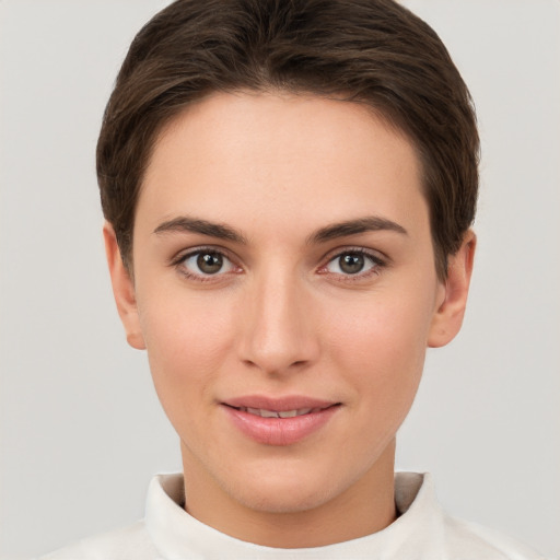 Joyful white young-adult female with short  brown hair and brown eyes