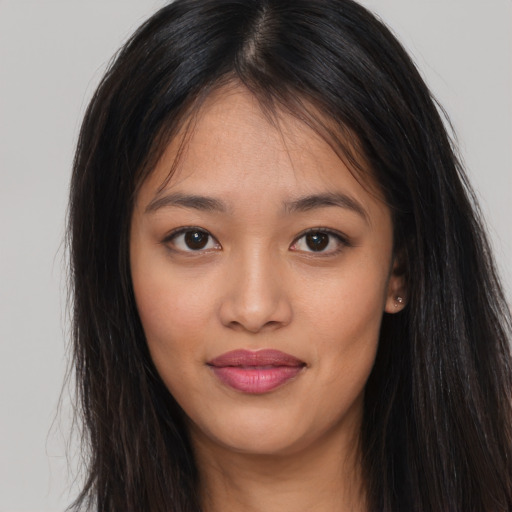 Joyful asian young-adult female with long  brown hair and brown eyes