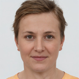 Joyful white adult female with short  brown hair and grey eyes