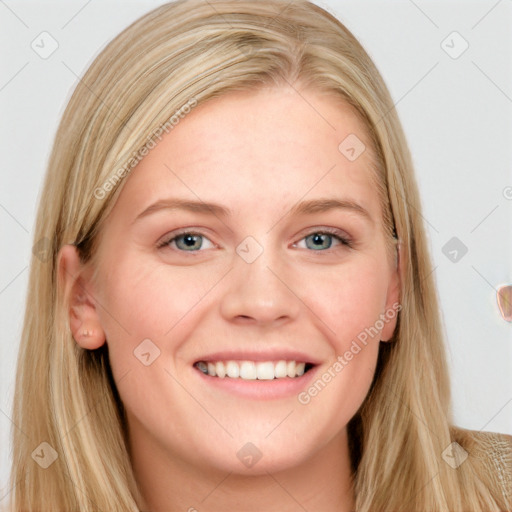 Joyful white young-adult female with long  brown hair and blue eyes