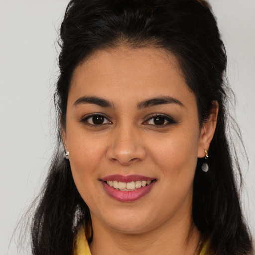 Joyful latino young-adult female with long  brown hair and brown eyes