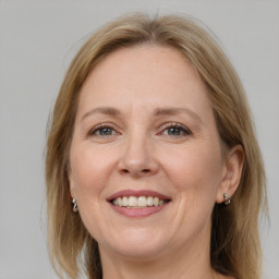 Joyful white adult female with medium  brown hair and grey eyes