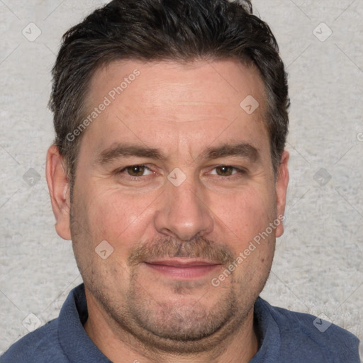 Joyful white adult male with short  brown hair and brown eyes