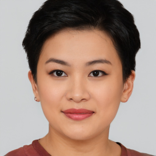 Joyful asian young-adult female with short  brown hair and brown eyes