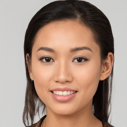 Joyful white young-adult female with long  brown hair and brown eyes