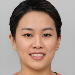 Joyful asian young-adult female with short  black hair and brown eyes