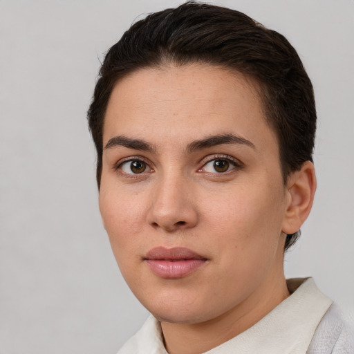 Joyful white young-adult female with short  brown hair and brown eyes