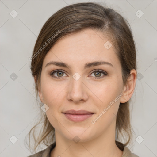 Joyful white young-adult female with medium  brown hair and green eyes