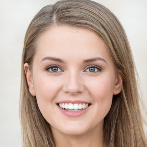 Joyful white young-adult female with long  brown hair and blue eyes