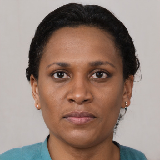 Joyful black adult female with short  brown hair and brown eyes