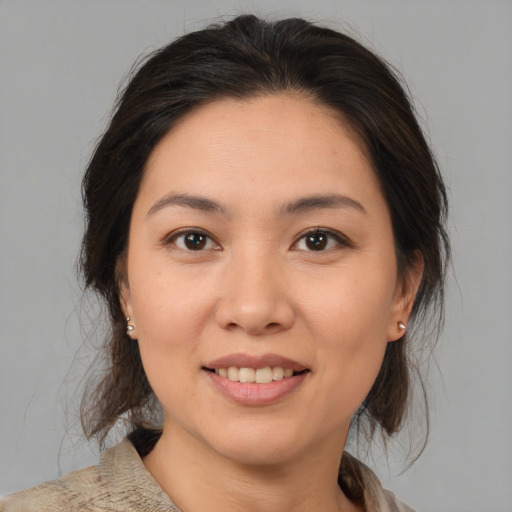 Joyful asian young-adult female with medium  brown hair and brown eyes