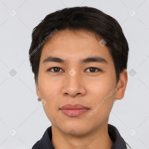 Joyful latino young-adult male with short  black hair and brown eyes