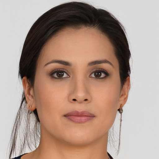 Joyful asian young-adult female with long  brown hair and brown eyes
