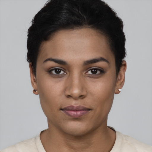 Joyful latino young-adult female with short  black hair and brown eyes